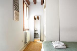 a white room with a bed and a window at Erbe Canal View Private House in Venice