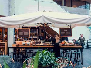 a woman standing in front of a table with food at U&Me; BW Signature Collection in Umeå