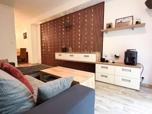 a living room with a couch and a coffee table at KaiTea Suites in Všemina