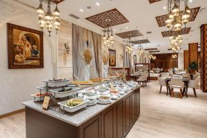 a buffet line with food on it in a restaurant at Ichan Qal'a Premium Class Hotel in Tashkent