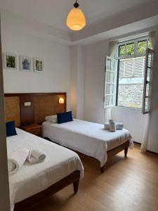 a bedroom with two beds and a window at Valhalla Panorama in Funchal +95 photos