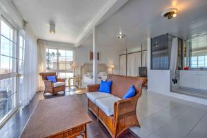 a living room with a couch and blue pillows at Seafront villa with jacuzzi in Maspalomas