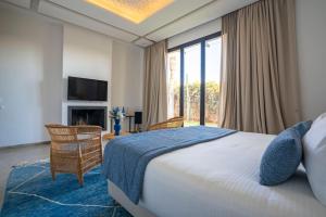 a bedroom with a large bed and a fireplace at Luxury Marrakech Villa marrakech pool,staff,brekfast included in Marrakesh +63 photos