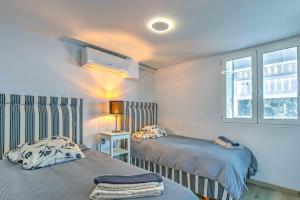 a bedroom with two beds and a window at Seafront villa with jacuzzi in Maspalomas +37 photos