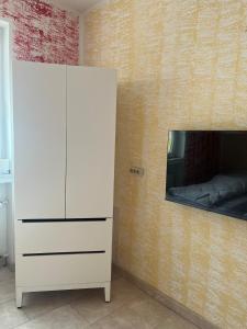a white cabinet with a mirror on a wall at Ferienwohnung Fatlume No 4 in Bad Honnef am Rhein