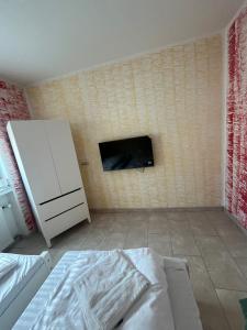 a room with a white cabinet and a wall with a fireplace at Ferienwohnung Fatlume No 4 in Bad Honnef am Rhein