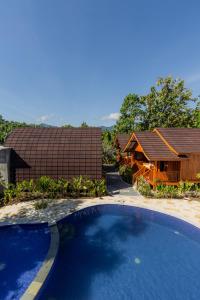 a large swimming pool in front of a house at Two Sisters Villa with Pool - Sire in Tanjung +20 photos