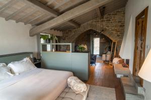 a bedroom with a bed and a brick wall at I Borghi dell'Eremo in Piegaro +196 photos