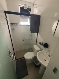 a small bathroom with a toilet and a sink at Smart Studio Lavras in Lavras +5 photos