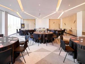 a large room with tables and chairs in it at Ibis Samarinda in Samarinda +69 photos