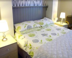 a bedroom with a bed with flowers on it at Marmion House Hotel in Wisbech