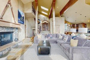 a living room with a couch and a fireplace at The Gold Flake Chalet in Breckenridge