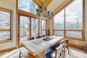 a dining room with a table and chairs and windows at The Gold Flake Chalet in Breckenridge