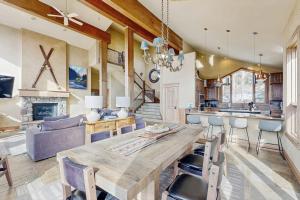 a kitchen and living room with a large wooden table at The Gold Flake Chalet in Breckenridge