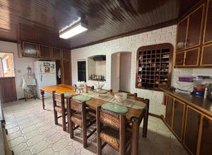 a kitchen with a table and chairs and a refrigerator at Wageney2us in Kempton Park