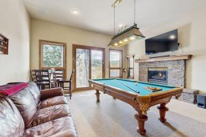 a living room with a pool table and a fireplace at The Gold Flake Chalet in Breckenridge +39 photos