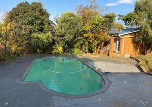 a swimming pool in the middle of a yard at Wageney2us in Kempton Park