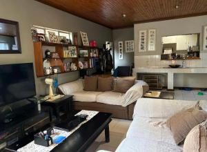 a living room with a couch and a tv at Wageney2us in Kempton Park