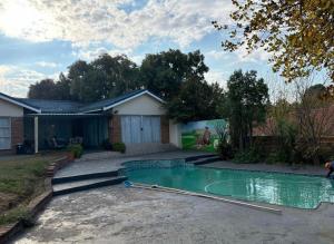 a swimming pool in the yard of a house at Wageney2us in Kempton Park