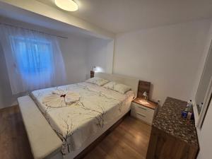 a bedroom with a large bed with a window at Apartments Drita in Baška