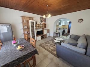 a living room with a table and a couch at Apartments Drita in Baška