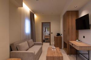 a living room with a couch and a table at Maistrali Luxury Living in Ouranoupoli +12 photos