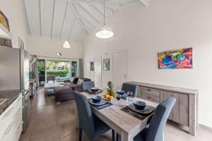 a dining room and living room with a table and chairs at Casa Verde - Blije Rust I in Dorp Sint Michiel