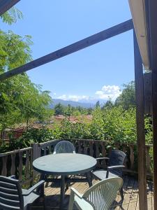 a table and chairs on a patio with a view at Mobile homes a la ferme in Ille-sur-Têt