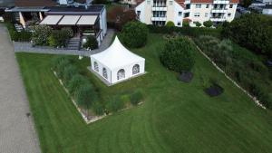 a small white building on top of a green field at Osterberg - Restaurant und Hotel in Hildesheim
