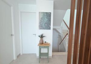 a hallway with a table with a vase on it at LUXURY VILLA ALMENDRO 15 WITH PRIVATE HEATED POOL at SANTA ROSALIA RESORT by PREMIUM SPAIN PROPERTIES in Torre-Pacheco +71 photos
