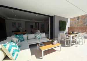 a living room with a couch and a table at LUXURY VILLA ALMENDRO 15 WITH PRIVATE HEATED POOL at SANTA ROSALIA RESORT by PREMIUM SPAIN PROPERTIES in Torre-Pacheco