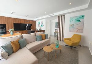 a living room with a couch and a chair at LUXURY VILLA ALMENDRO 15 WITH PRIVATE HEATED POOL at SANTA ROSALIA RESORT by PREMIUM SPAIN PROPERTIES in Torre-Pacheco