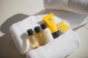 a group of three bottles of essential oils on a towel at The Mare Pool Villa Pension in Taean