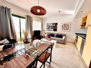 a living room with a table and a couch at Departamento Corriquia in Playa Blanca