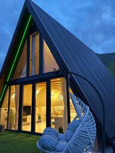 a house with a hammock in front of it at "Vista Frame" JAZ - lake view in Višegrad +4 photos