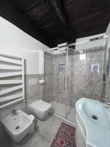 a bathroom with a sink and a toilet and a shower at Il Sasso appartamento in Orta San Giulio +18 photos