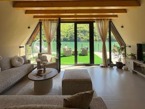a living room with a couch and a table at "Vista Frame" JAZ - lake view in Višegrad