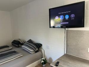 a flat screen tv hanging on a wall at Königshof Studio in Monschau