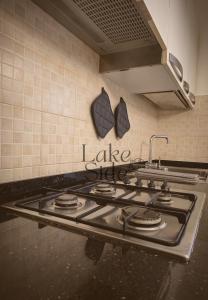 a kitchen stove top with the words lake chef on the wall at Bijou - Lake side apartments in Sandra