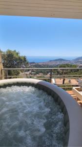 a hot tub on a balcony with water at Tutto Passa Lloret in Lloret de Mar