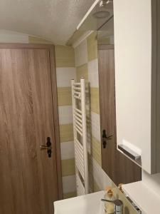 a bathroom with a sink and a mirror at Apartma Elza in Tržič +21 photos