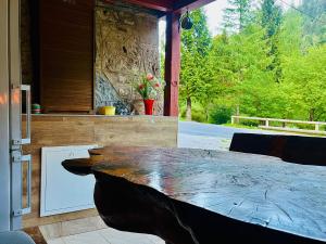 a kitchen with a large wooden table in a room at Apartma Elza in Tržič