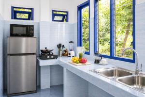 a kitchen with a stainless steel refrigerator and a sink at Archie Village in Hinkong