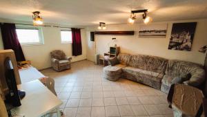 a living room with a couch and a table at Souterrainwohnung in Niederau in Niederau