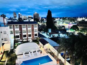 a view of a city with a building and a swimming pool at Vcp urban suites in Villa Carlos Paz