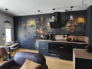 a kitchen with a painting of a bear on the wall at Escale à Clisson - l'Hippo Loft in Clisson +2 photos