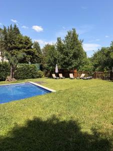 a person standing in a yard next to a swimming pool at Bungalow Gerês - Pichoses Camping in Rio Caldo