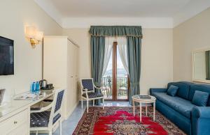 a living room with a couch and a table at Hotel Iaccarino in SantʼAgata sui Due Golfi