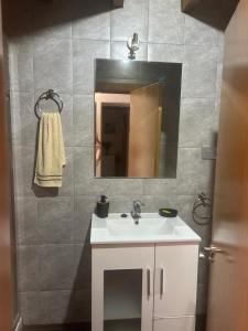 a bathroom with a white sink and a mirror at El Descanso Lastres in Colunga +10 photos