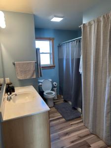 a bathroom with a sink and a toilet and a shower at YellowstoneMigrant in Emigrant +37 photos